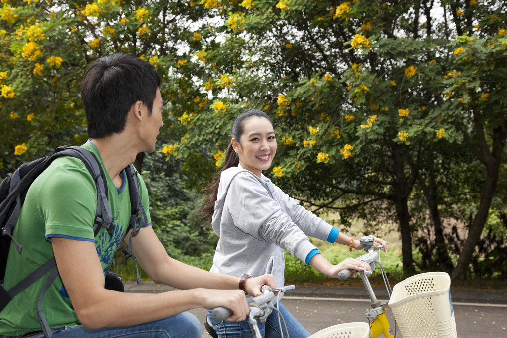 年轻大学生在校园里骑车