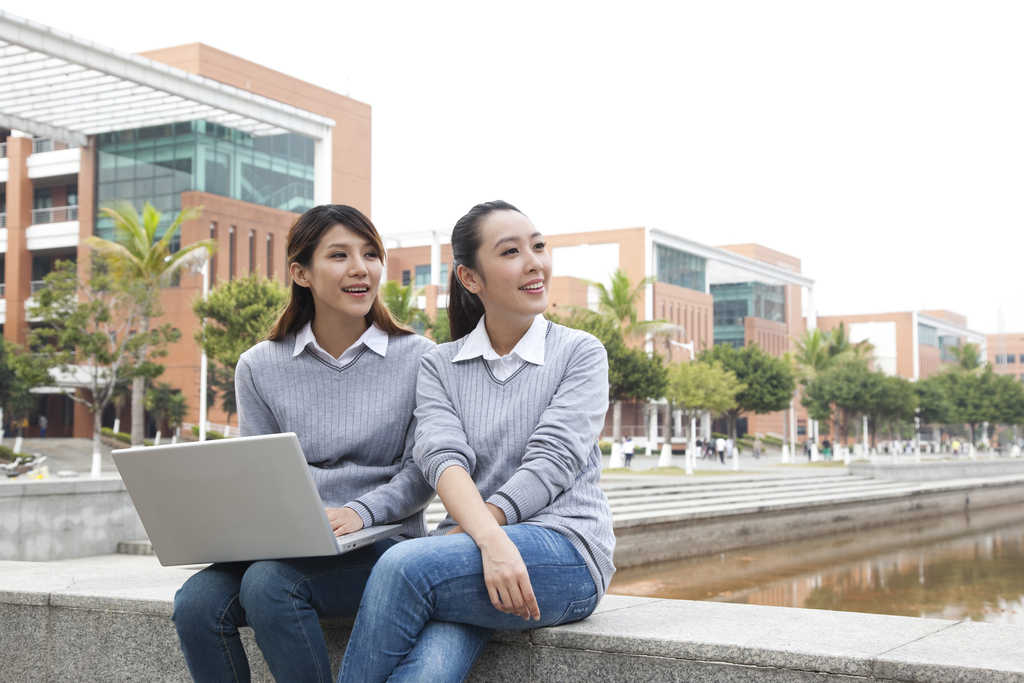 年轻大学生在校园里使用笔记本电脑