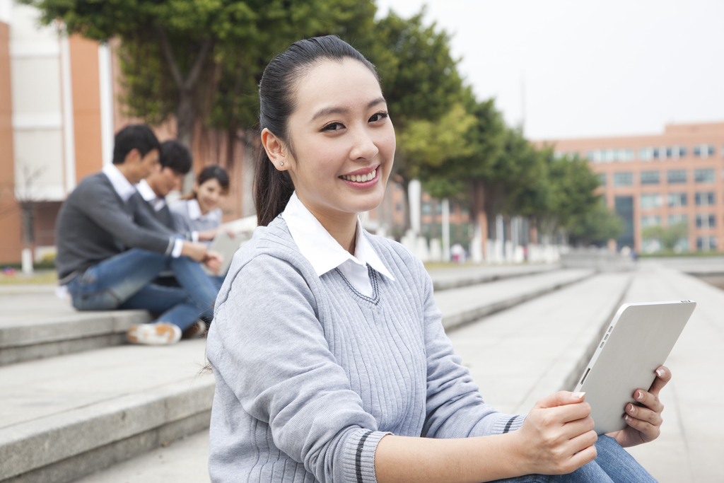 年轻大学生在校园里使用平板电脑图片