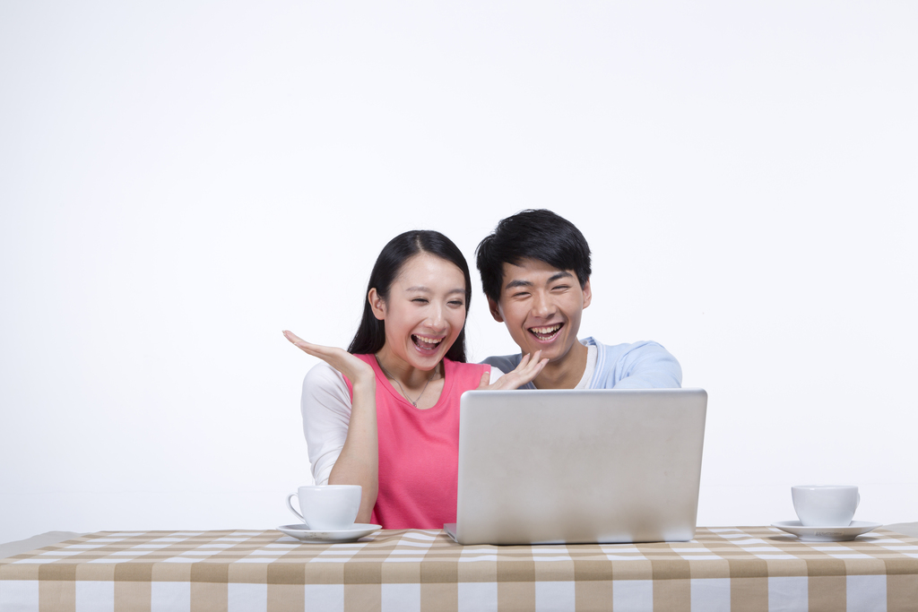 棚拍年轻情侣使用笔记本电脑图片