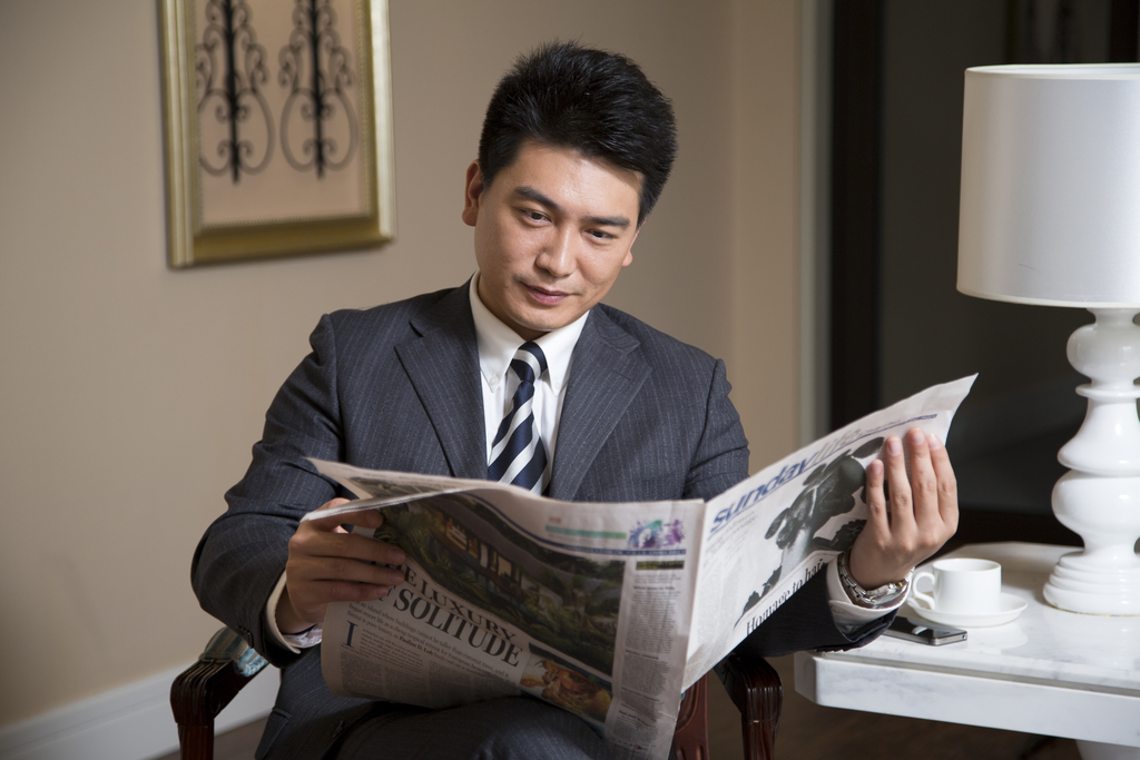 中年商务男士在书房看报纸