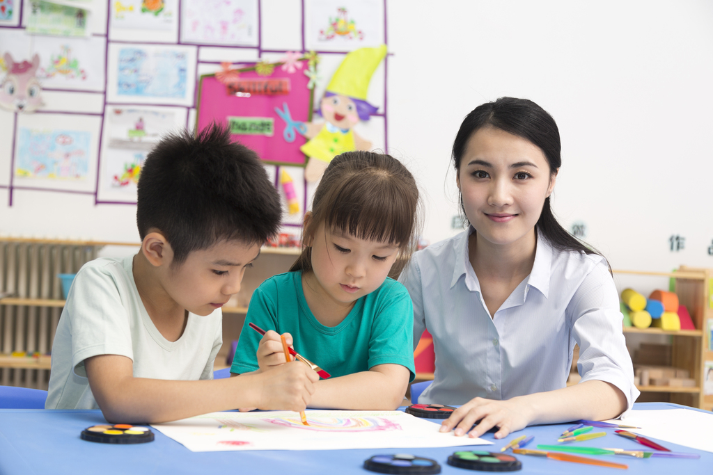 幼儿园女老师辅导儿童画画