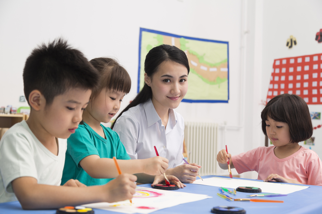 幼儿园女老师辅导儿童画画图片