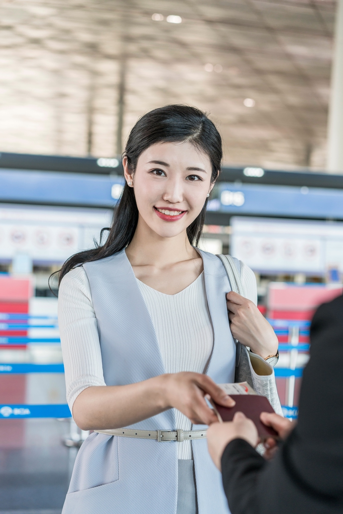 年轻商务女士在机场出示护照 图片