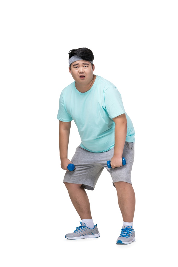 肥胖的青年男子在做运动图片