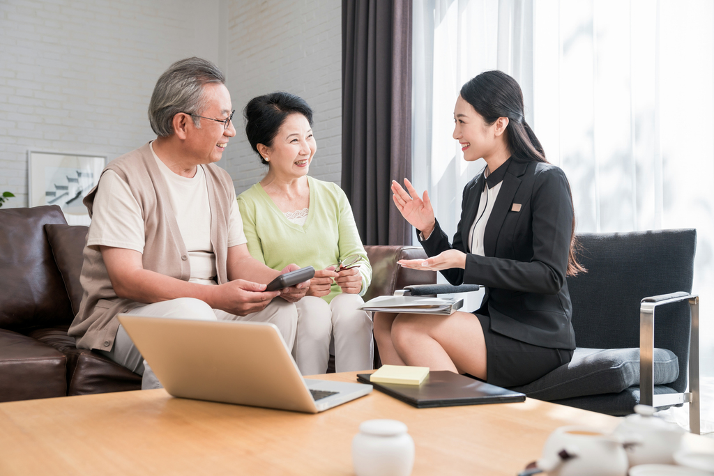 年轻女子向一对老夫妻介绍产品图片