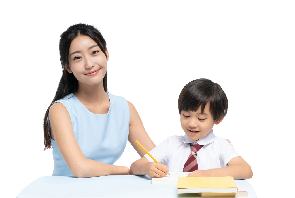 年轻女老师辅导小男孩学习图片