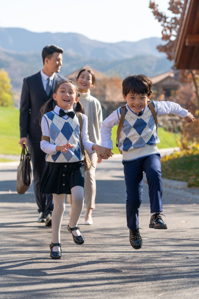 年轻夫妻送孩子去上学图片