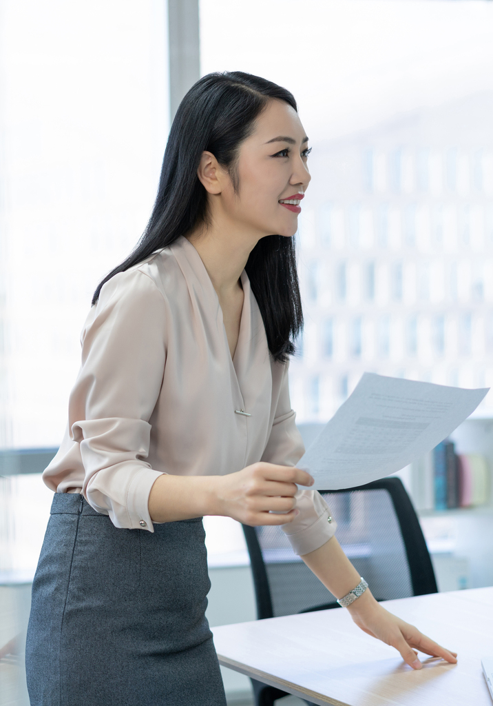 年轻商务女士拿着文件