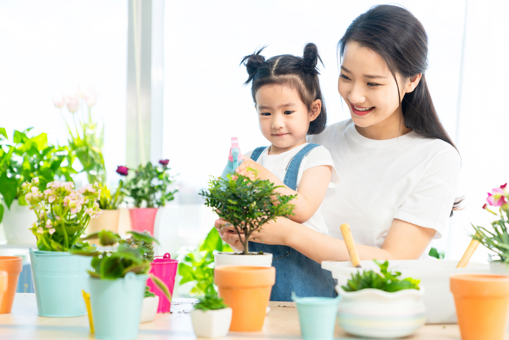 快乐的母女俩在家种植盆栽