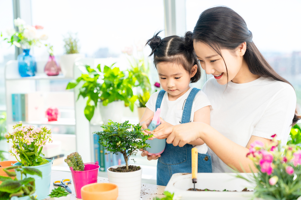 快乐的母女俩在家种植盆栽