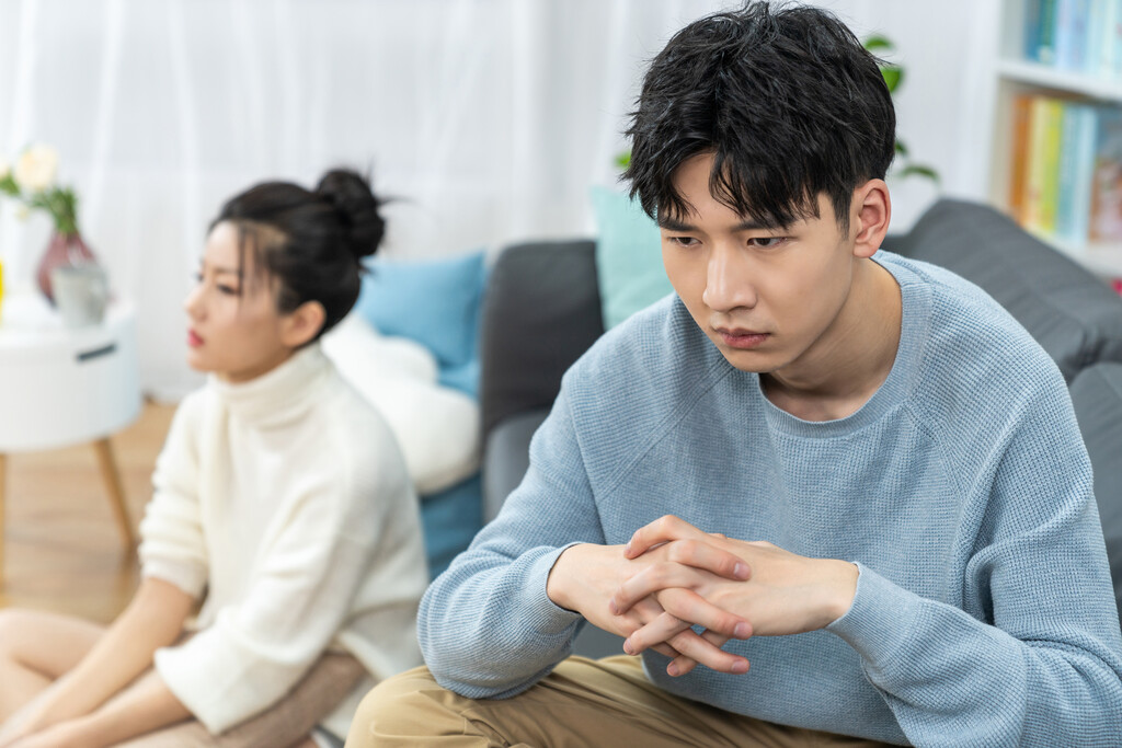 年轻情侣在客厅沙发上争吵图片