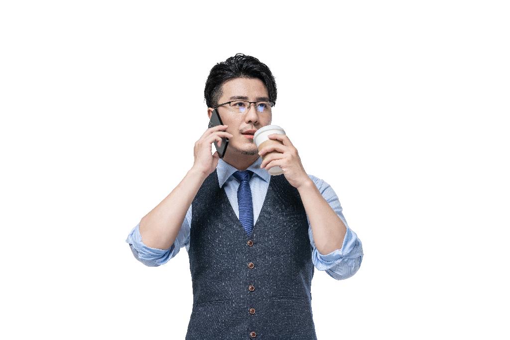 商务男士拿着咖啡使用手机图片