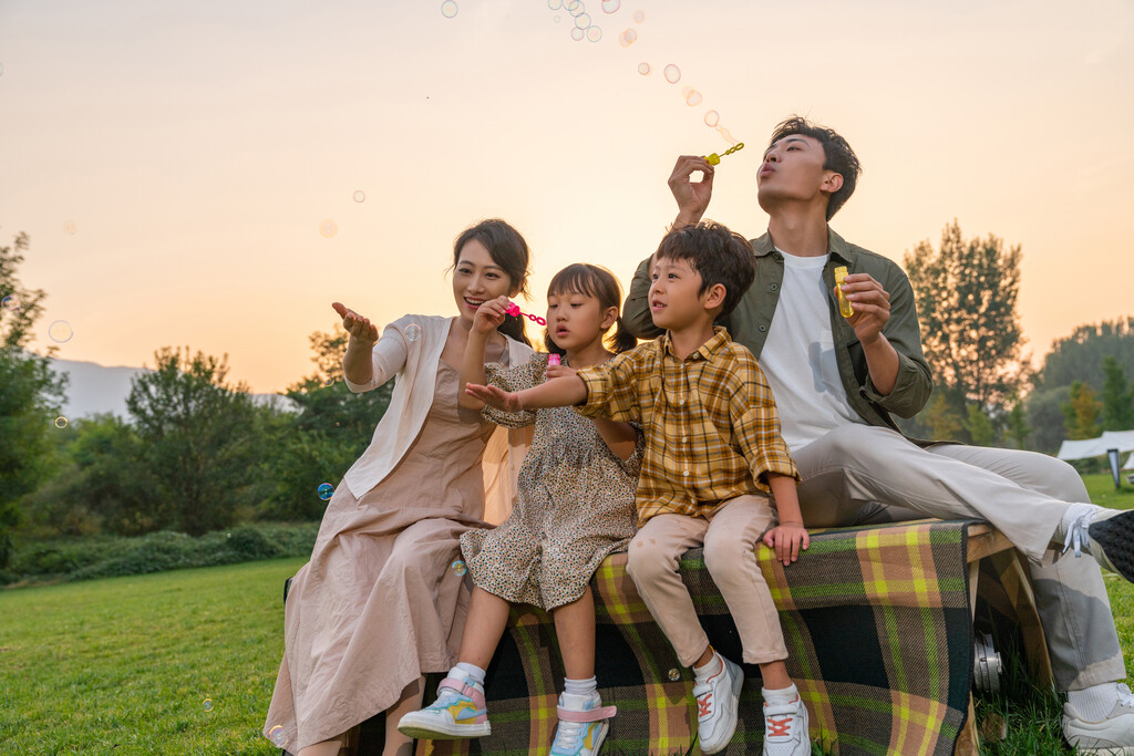 一家人在夕阳下吹泡泡图片